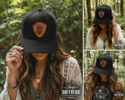 A collage showing a woman outdoors in a forest wearing a black trucker-style baseball cap with a brown shield patch that reads 'Stay Wild Chicks.' The main view is a close-up, with two smaller side views showing different angles of the cap on the model.